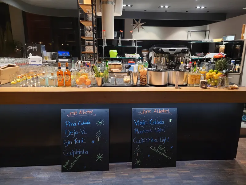 Aufgebaute Cocktailbar mit Kreidetafeln in einer Veranstaltungshalle